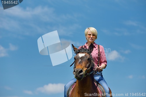 Image of happy woman  ride  horse