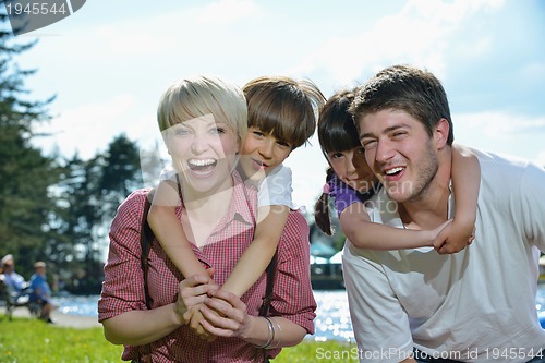 Image of happy young family have fun outdoors