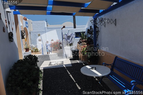 Image of Greek woman on the streets of Oia, Santorini, Greece