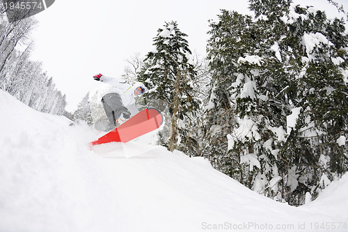 Image of snowboarder on fresh deep snow