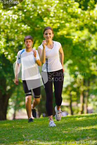 Image of Young couple jogging