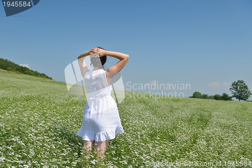 Image of Young happy woman in green field
