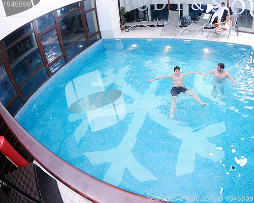 Image of young people group at spa swimming pool