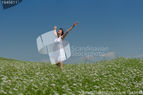 Image of Young happy woman in green field