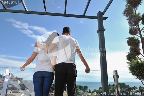 Image of couple relaxing on balcony