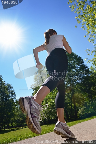 Image of Young beautiful  woman jogging at morning in park