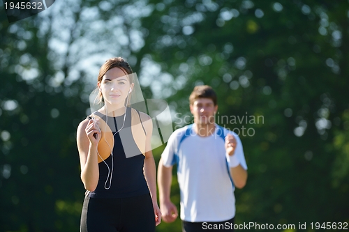 Image of Young couple jogging at morning