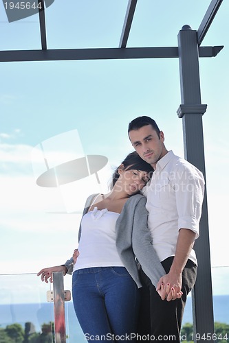 Image of couple relaxing on balcony