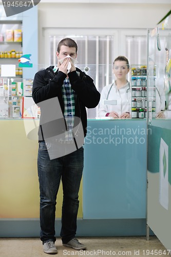 Image of pharmacist suggesting medical drug to buyer in pharmacy drugstor