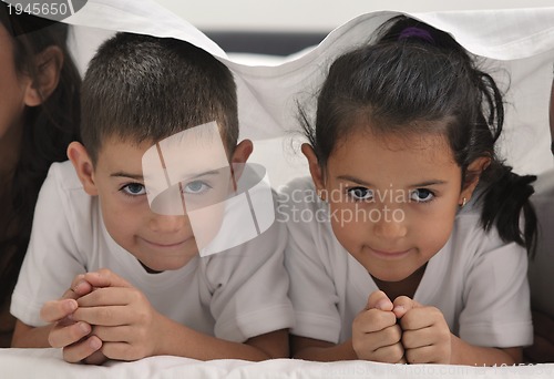 Image of happy young Family in their bedroom