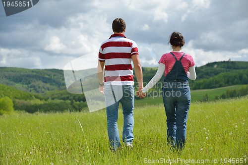 Image of Portrait of romantic young couple smiling together outdoor