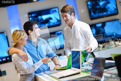 Image of Young couple in consumer electronics store