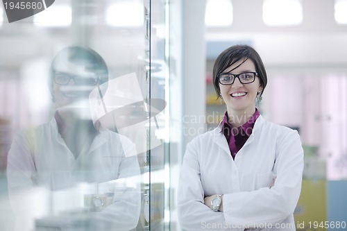Image of pharmacist chemist woman standing in pharmacy drugstore