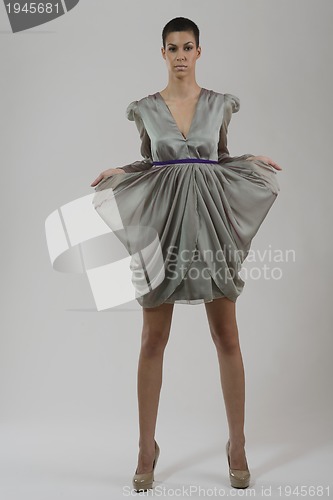 Image of elegant woman in fashionable dress posing in the studio