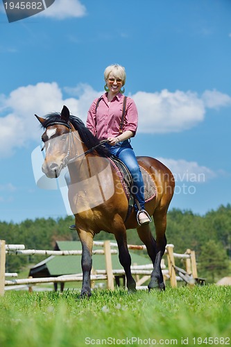 Image of happy woman  ride  horse