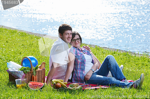 Image of happy young couple having a picnic outdoor