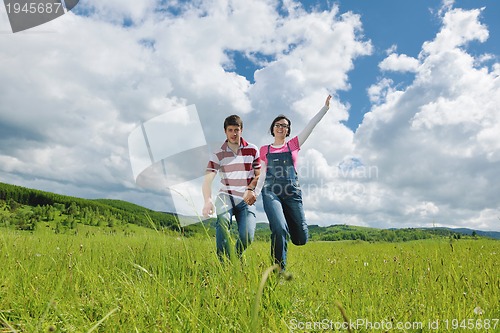 Image of Portrait of romantic young couple smiling together outdoor