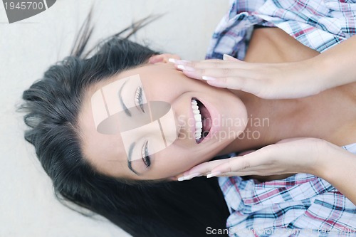 Image of beautiful young lady posing in garden