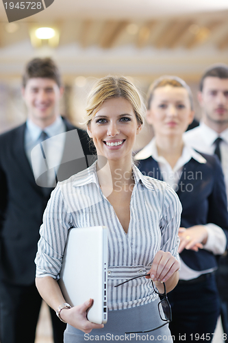 Image of business woman standing with her staff at conference