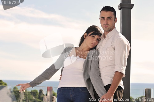 Image of couple relaxing on balcony