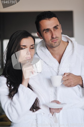 Image of Young love couple taking fresh morning cup of coffee