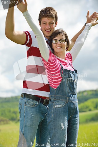 Image of Portrait of romantic young couple smiling together outdoor