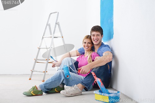 Image of happy young cople relaxing after painting in new home