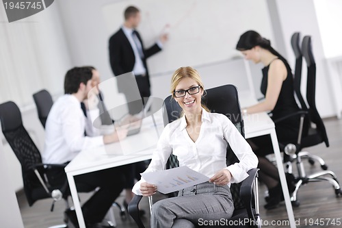 Image of business woman with her staff in background
