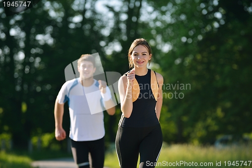 Image of Young couple jogging