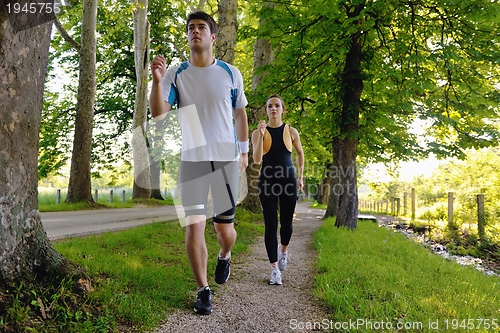 Image of Young couple jogging