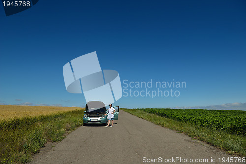 Image of woman with broken car