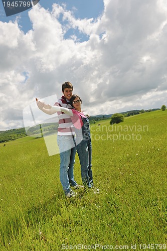 Image of Portrait of romantic young couple smiling together outdoor