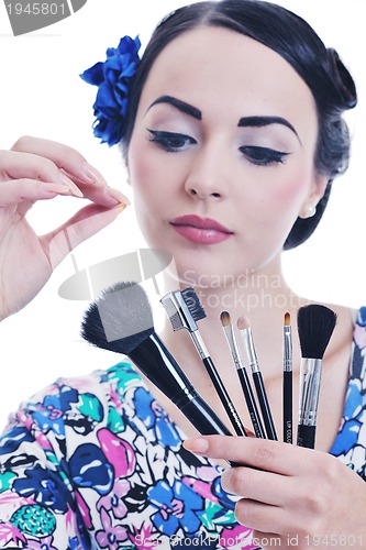 Image of beautiful young woman applying makeup