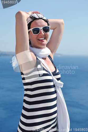 Image of Greek woman on the streets of Oia, Santorini, Greece