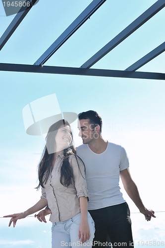 Image of couple relaxing on balcony