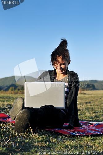 Image of young teen girl work on laptop outdoor