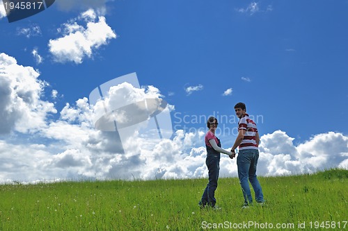 Image of Portrait of romantic young couple smiling together outdoor
