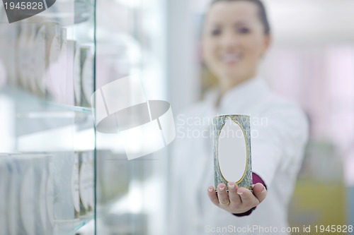 Image of pharmacist chemist woman standing in pharmacy drugstore