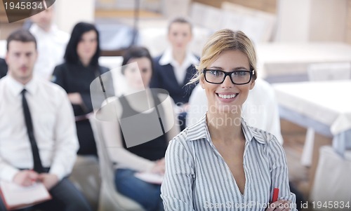 Image of business woman standing with her staff at conference