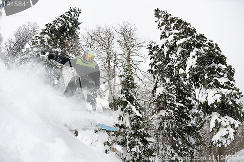 Image of snowboarder on fresh deep snow