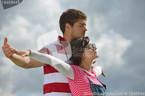 Image of Portrait of romantic young couple smiling together outdoor