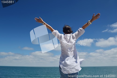 Image of happy young woman with spreading arms to sky