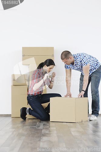 Image of Young couple moving in new home