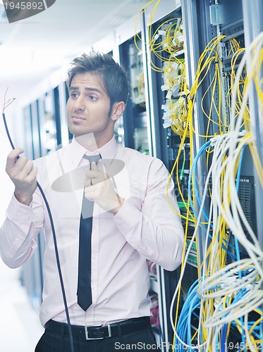 Image of young it engeneer in datacenter server room