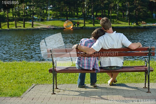 Image of Portrait of romantic young couple smiling together outdoor