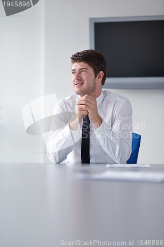 Image of happy young business man at office