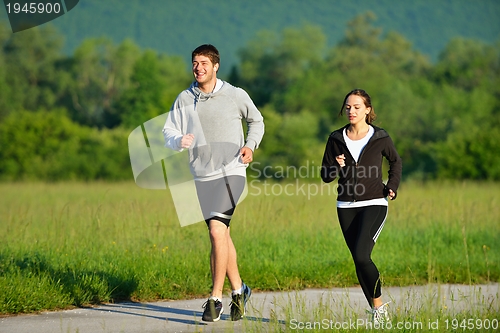 Image of Young couple jogging