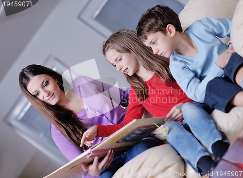 Image of young mom play with their kids at home and reading book