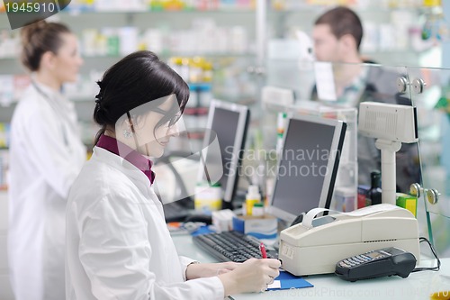 Image of pharmacist suggesting medical drug to buyer in pharmacy drugstor