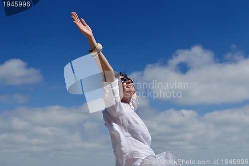 Image of happy young woman with spreading arms to sky